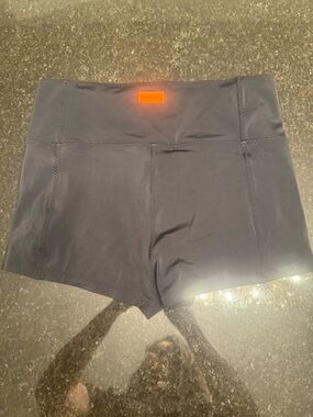 Fabletics Black Stretch Athletic Shorts with Orange Logo